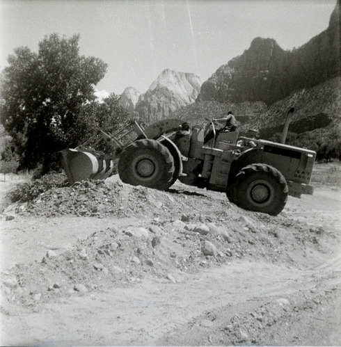 Excavator clearing dirt during east side road repair and turn out construction.