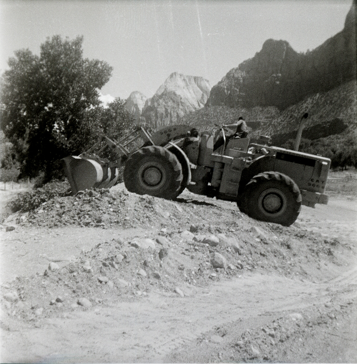 Excavator clearing dirt during east side road repair and turn out construction.