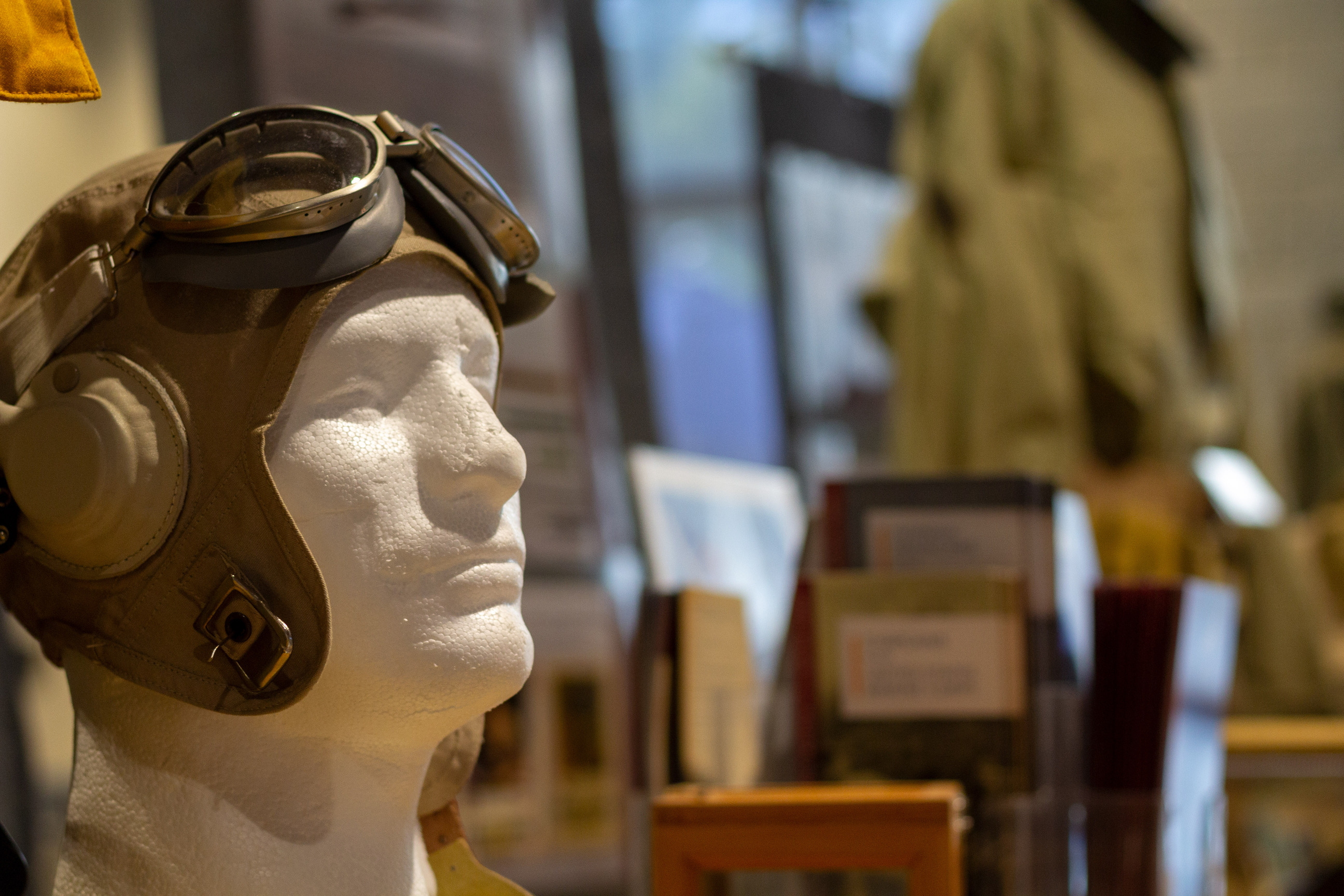 An exhibit on a table featuring a World War 2 fighter pilot hat.