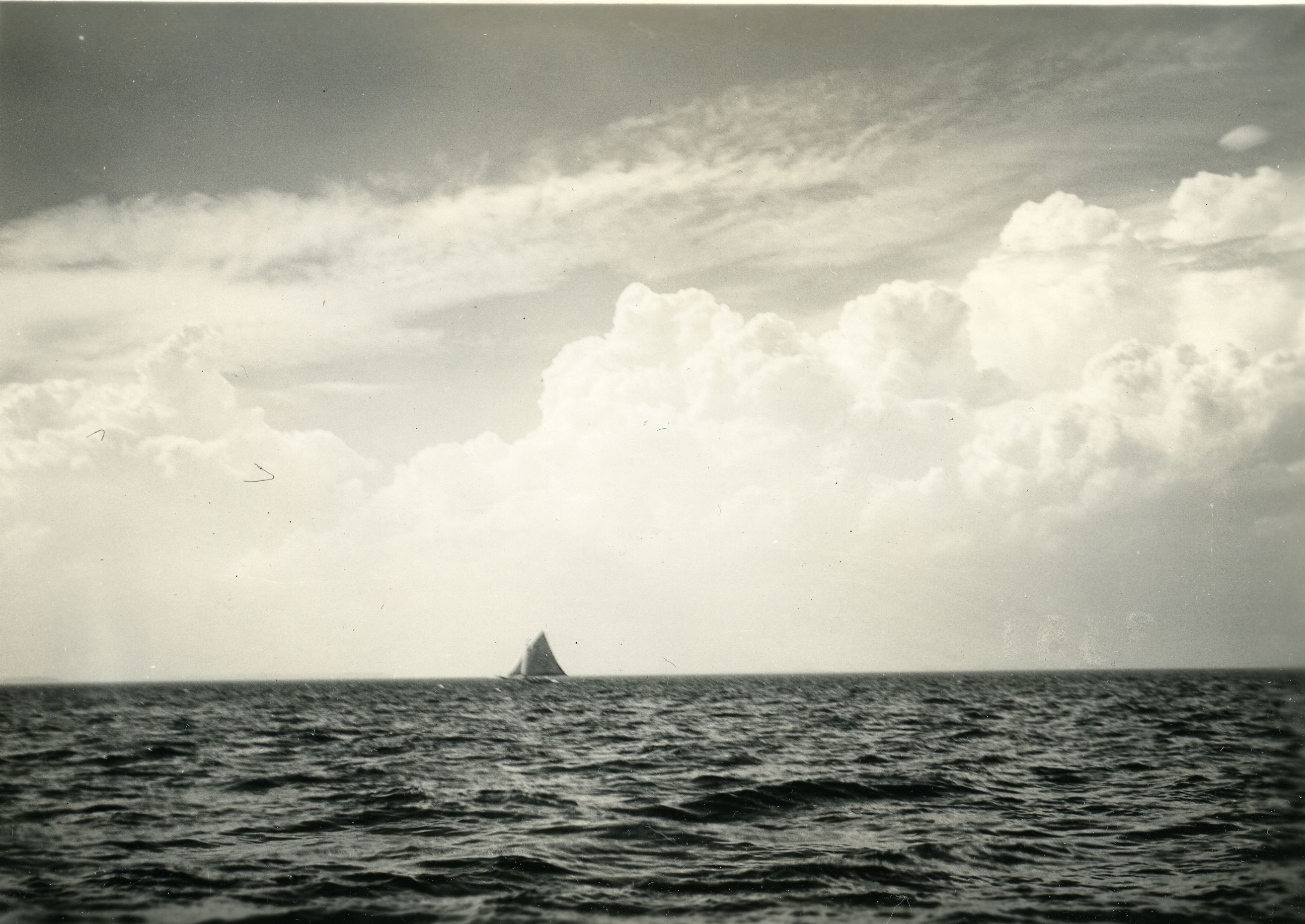 SAILBOAT AND CUMULUS CLOUDS