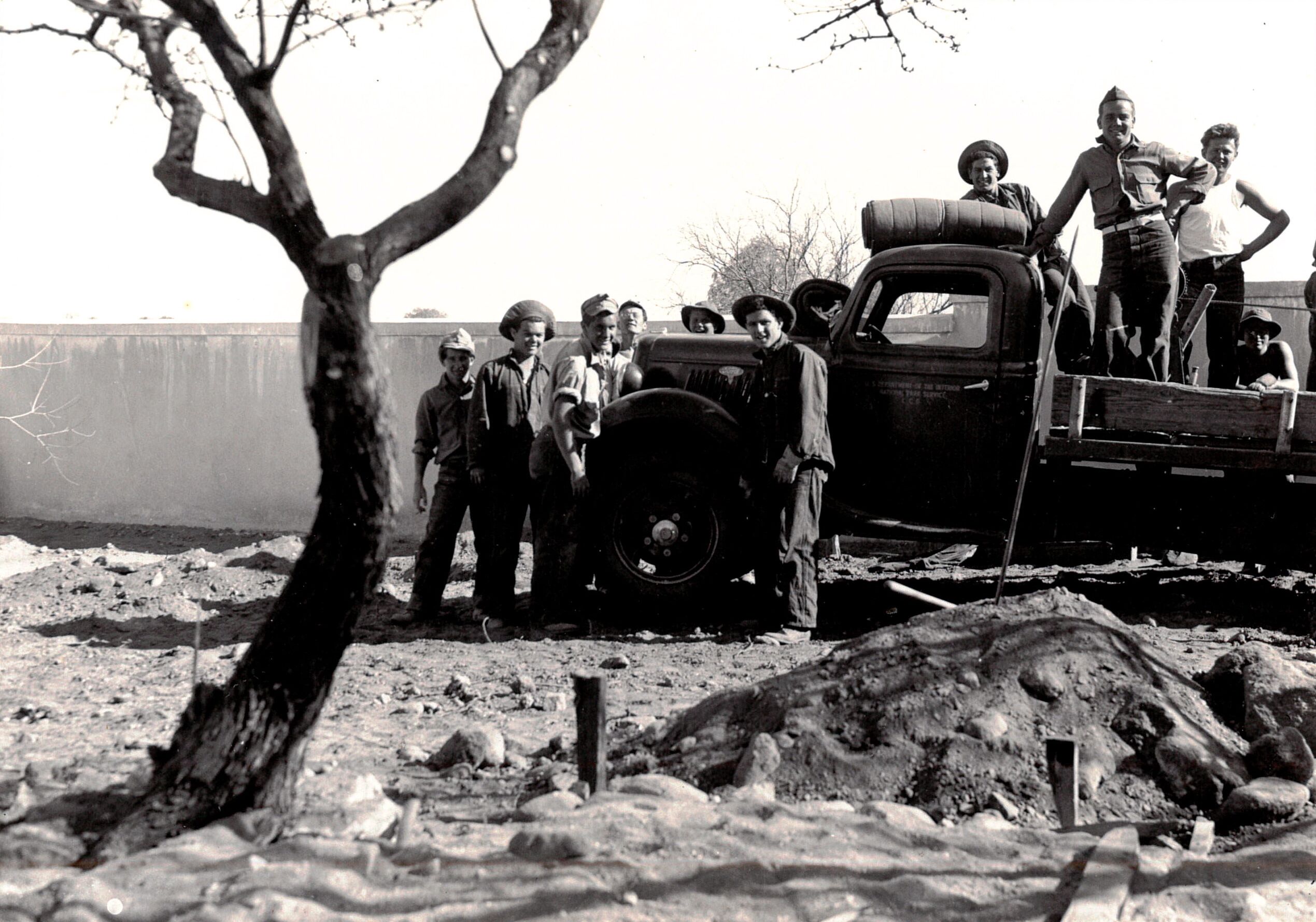 historic photo of boys around flatbed truck in courtyard garden in progress