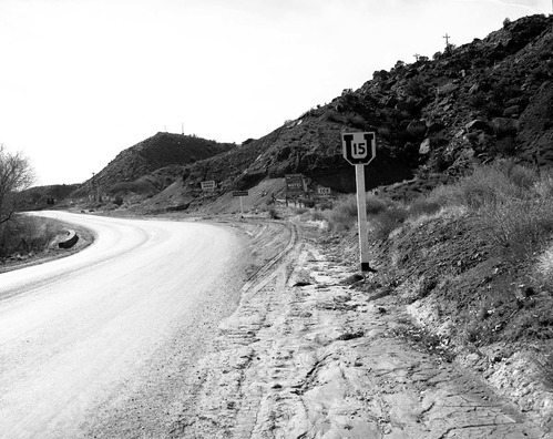 Roadside signs on State Route 15 (now State Route 9) in Springdale. Group of signs about 200 yards from South Entrance to park, across the highway from Zionville Market and Motel. Photographs for documentation for proposed clean up of undesirable signage and debris on the access route to Zion National Park.