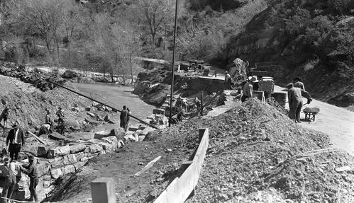 Repair of flood damage at the hog wall near the Utah Parks Company utility area. Rock wall revetment.