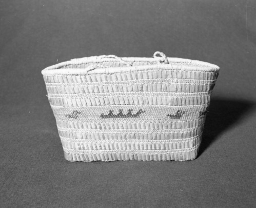 Marie Rozier Collection, Catalog No. 2-CAN-8. Object: Makah carrying basket. Dimensions: 13 x 6 x 7 1/2". Materials: Red cedar, raffia, dyed grass. Technology: Plaited and plain twined, up to right slant of turns. Made for sale. Collection History: Purchased in Port Angeles, Washington, 1969. Photographed by Michael Dixon in December 1982. Catalogued by Craig Bates and Barbara Beroza. Yosemite Collections, National Park Service.