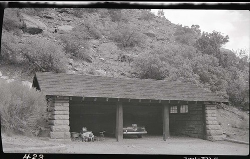 Three car garage w/ car parked inside.