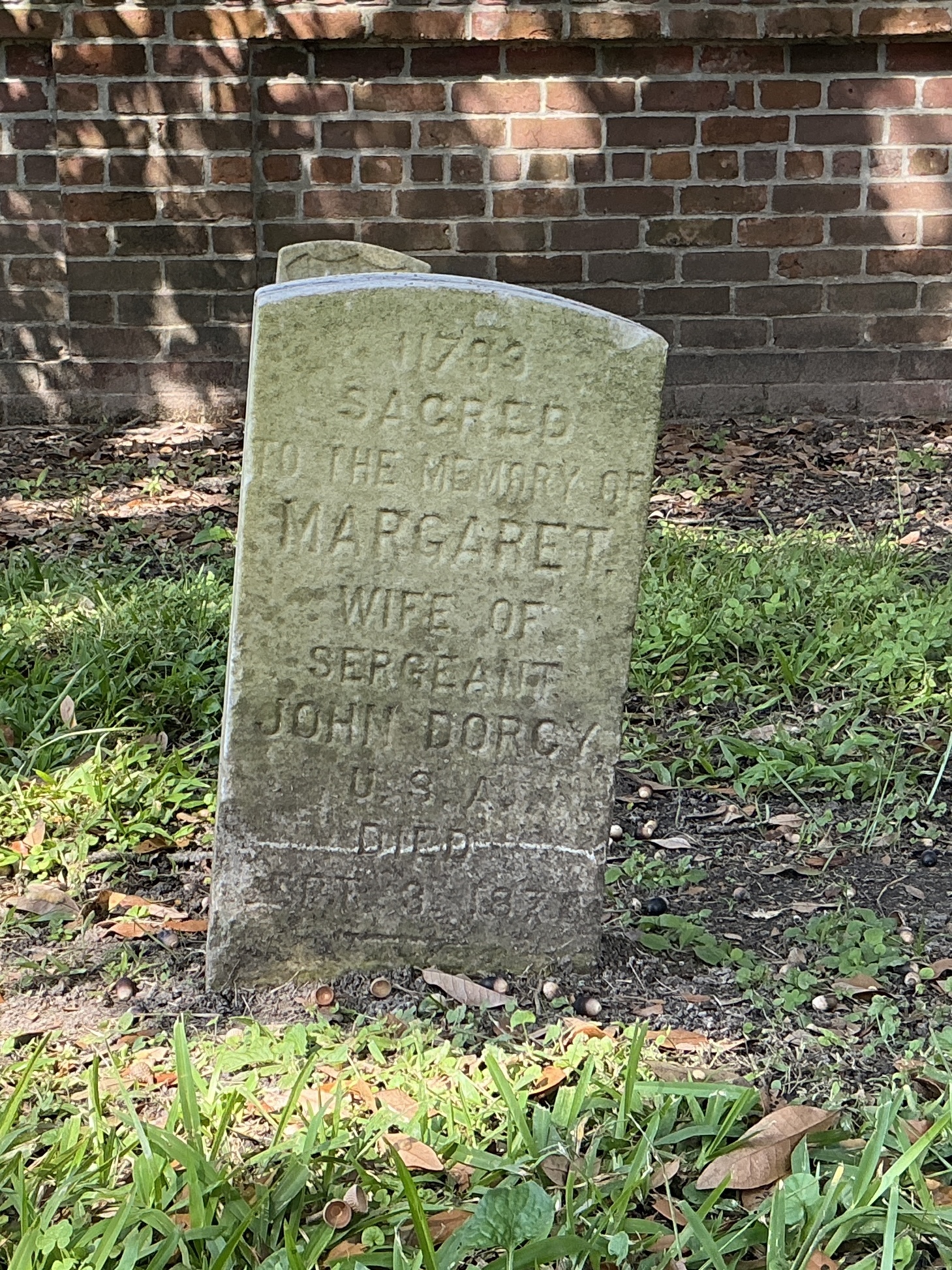 Front of historic upright marble headstone with flat face.