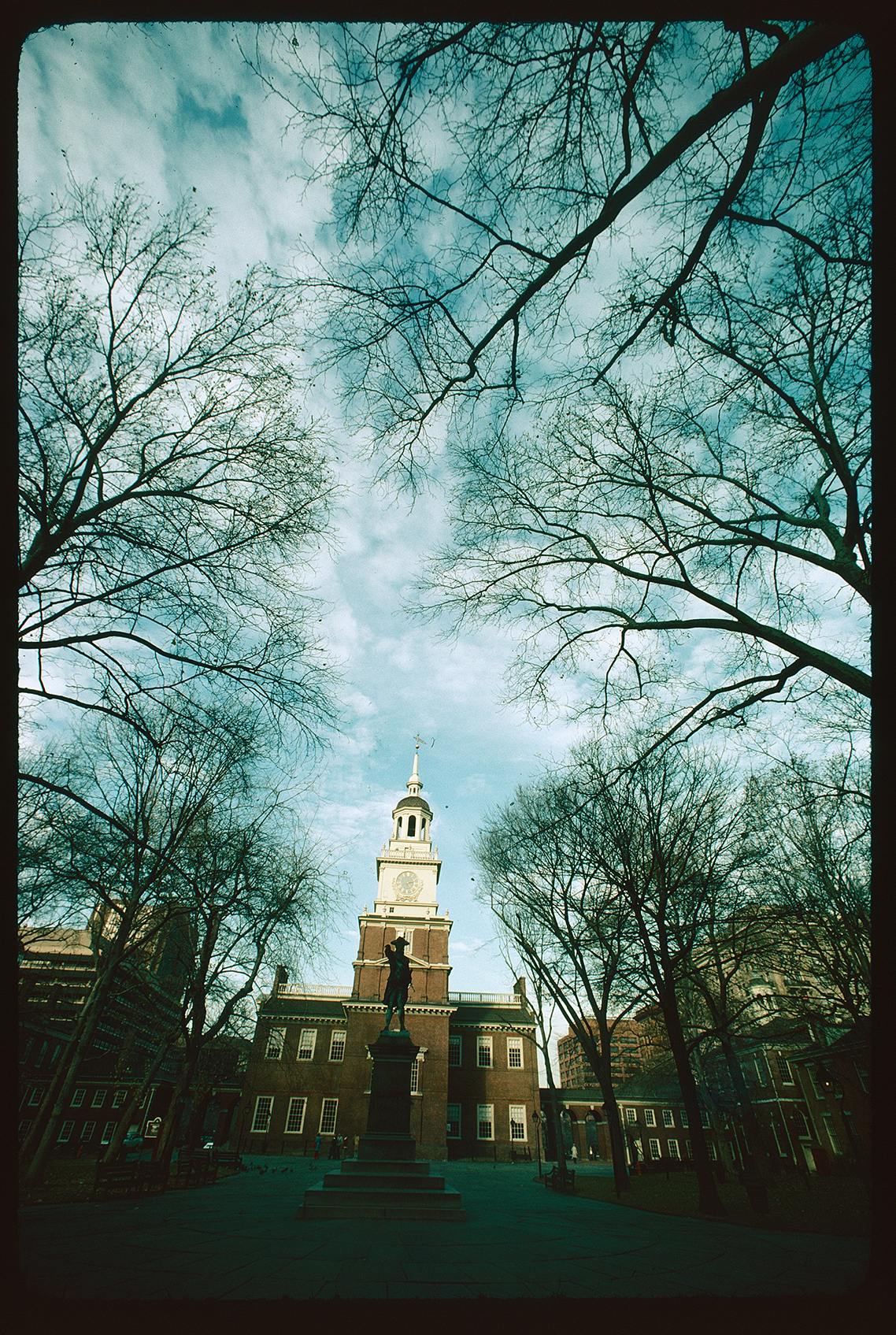 Independence Square. Looking up northeast past John Barry statue at Independence Hall exterior. Sky mostly in frame. Tower clock, nearly 2:25 PM.