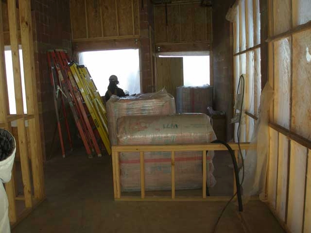 Rolls of insulation are piled in what will be the new Visitor Center bookstore, making it well insulated.