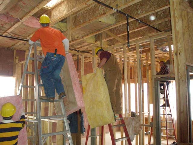 Thick insulation is tucked in between the joists in the ceiling of the new Cultural Heritage Center.