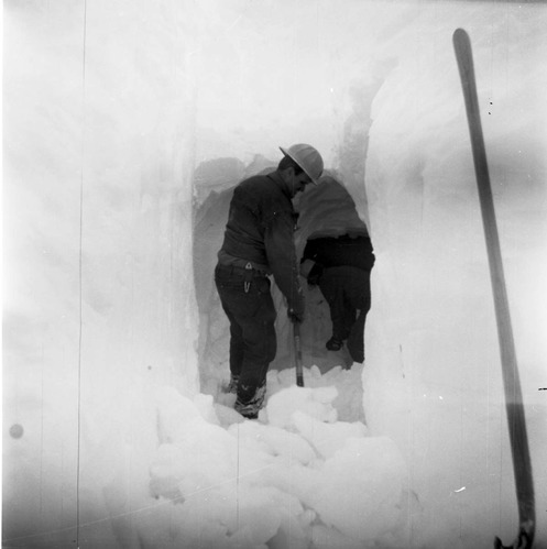 BW Photos showing rangers digging out the visitor center from snowdrift.