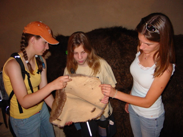 A group of people checking an item.