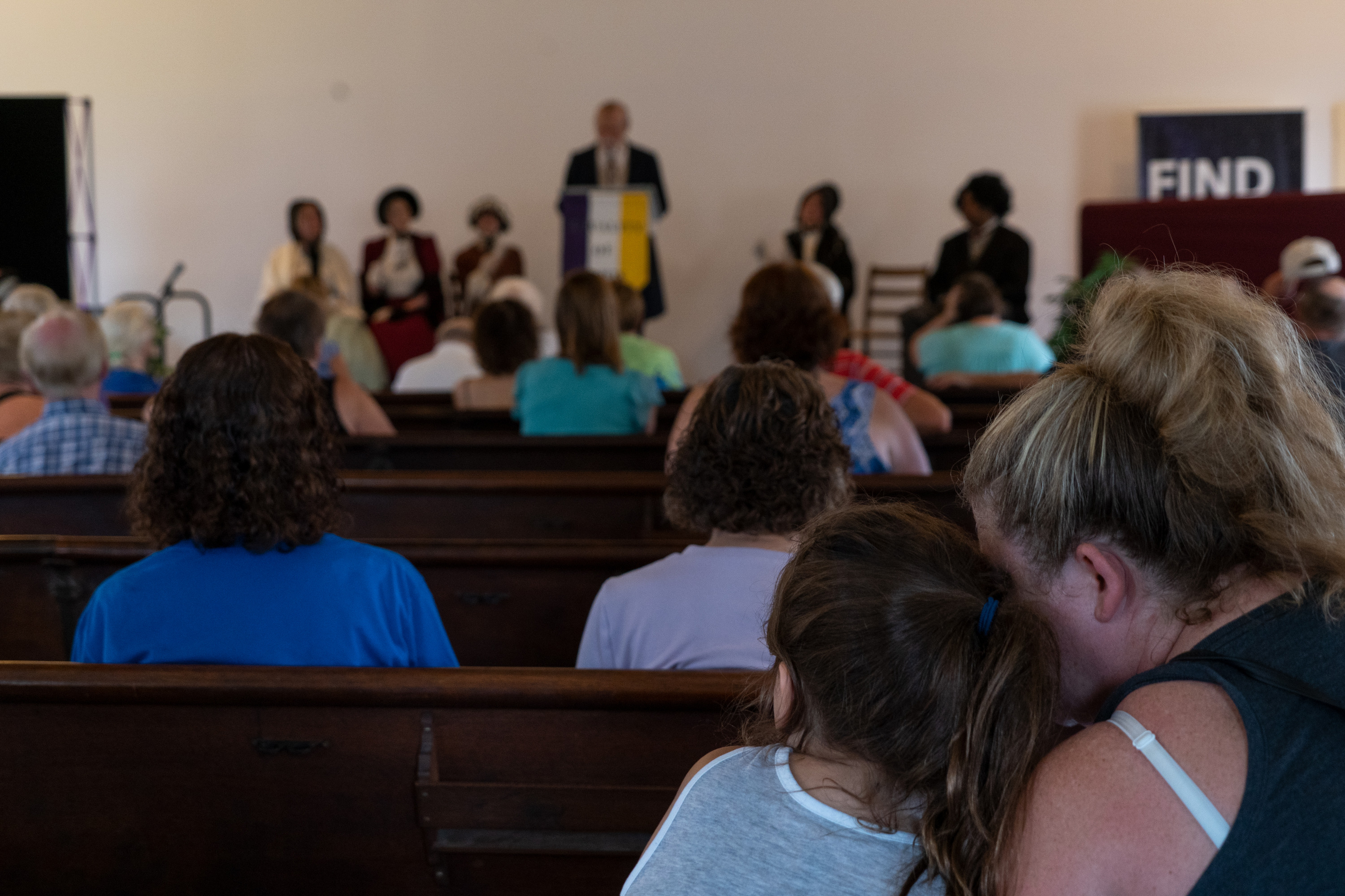 An audience watching a play in a historical building. 