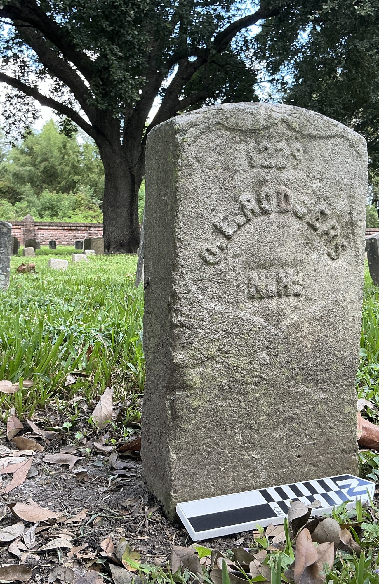 Extra image of historic upright marble headstone with recessed shield face.
