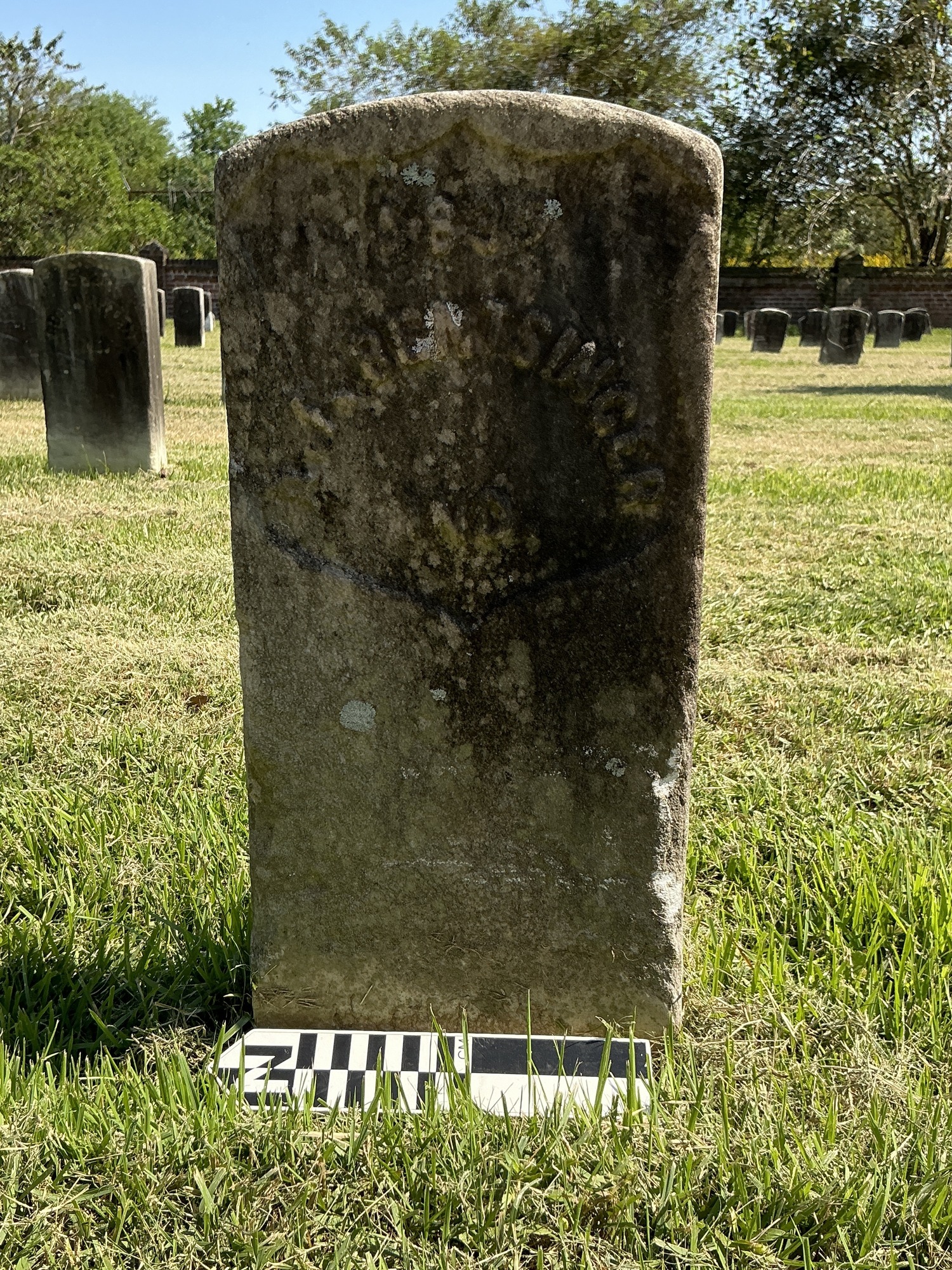 Extra image of historic upright marble headstone with recessed shield face.