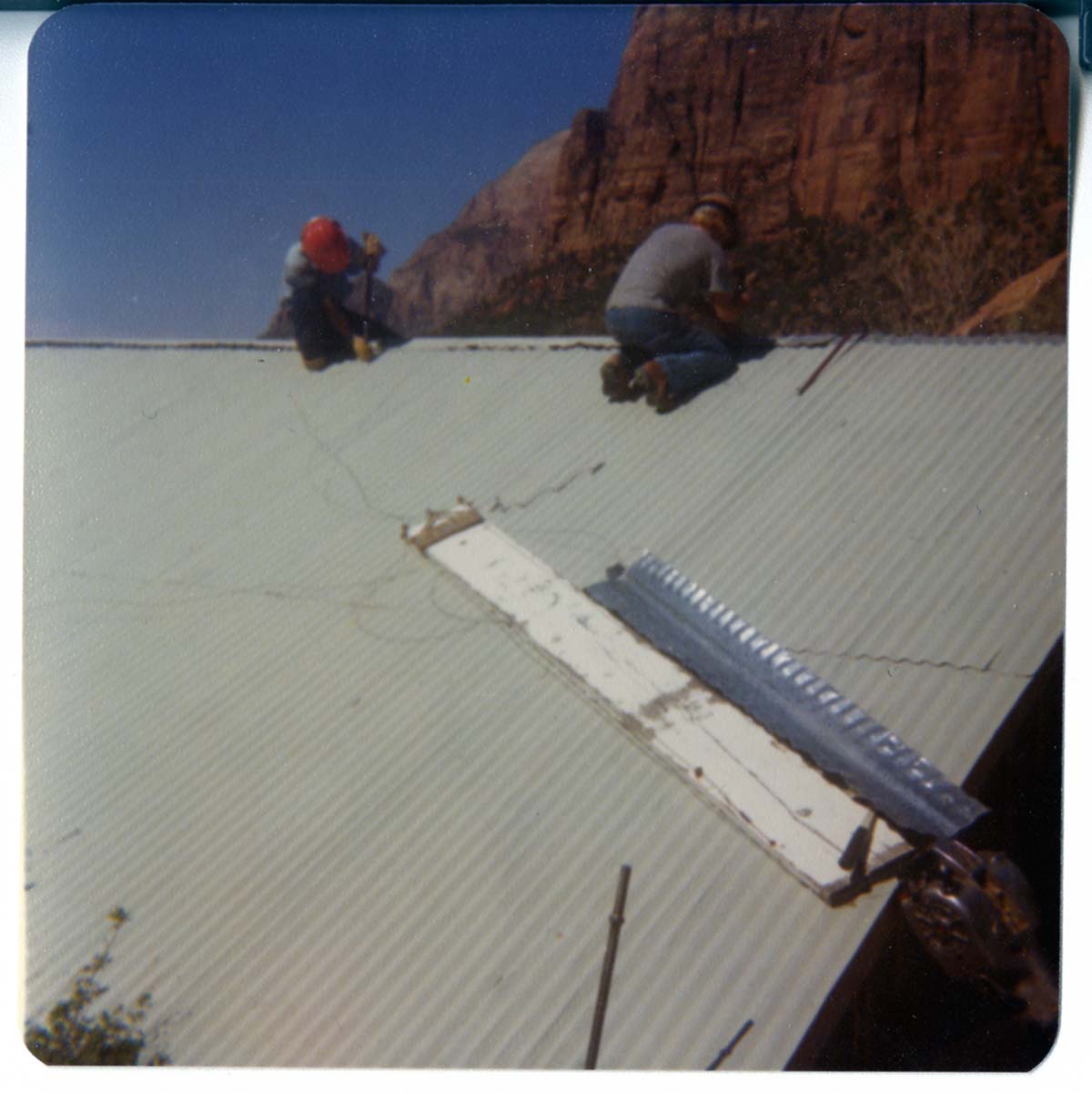 Workers working on the reroofing of Birch Creek Horse Barn.