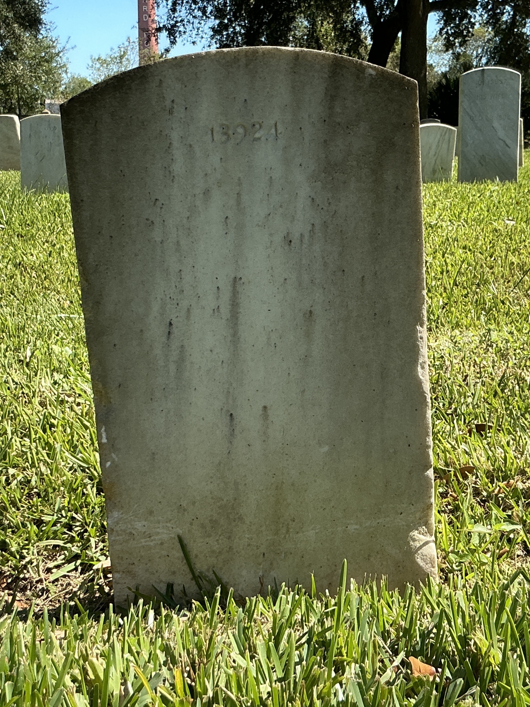 Back of upright marble headstone with flat face.