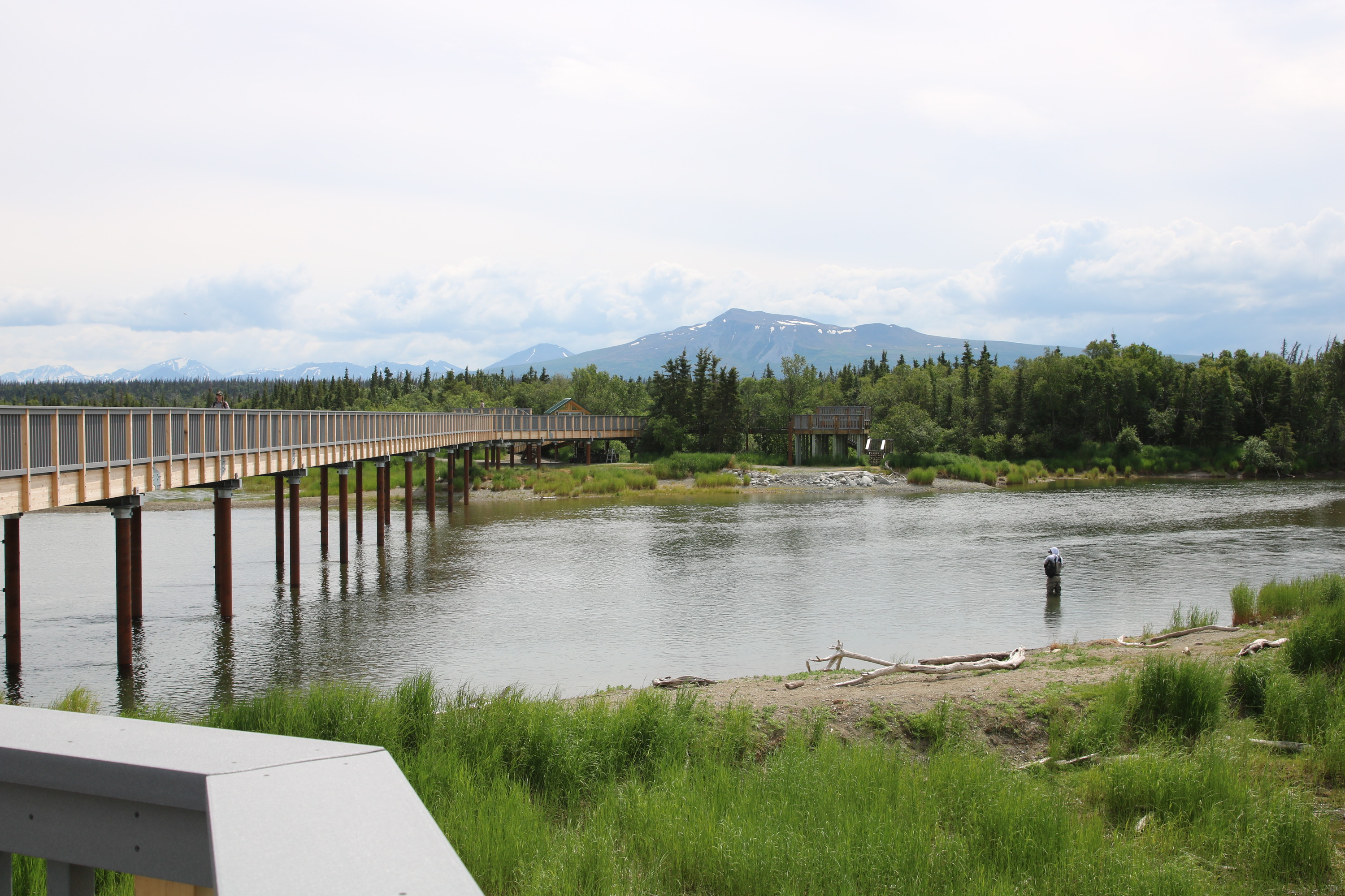 view down onto river with anglers upstream of elevated bridge
