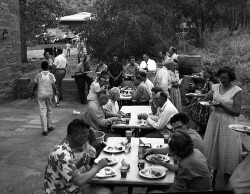 Barbecue picnic for seasonal staff. Employees, friends, and family eat and socialize outside the ranger dormitory by park headquarters.