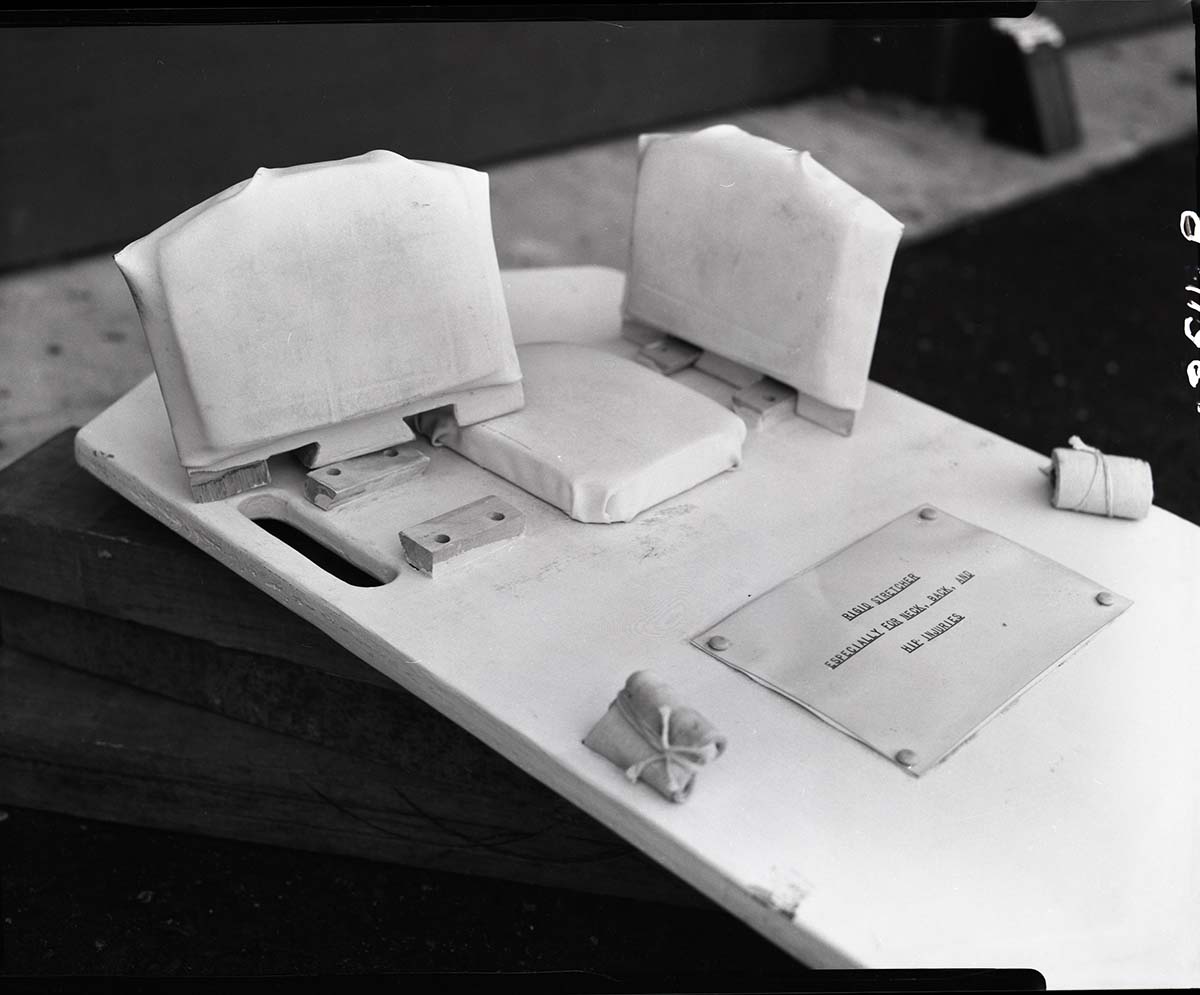 Special apparatus for stretcher for first-aid in neck injuries designed by Rudy Lueck.