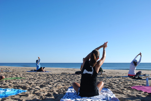Ranger Jenna guides participants through a yoga practice on the beach