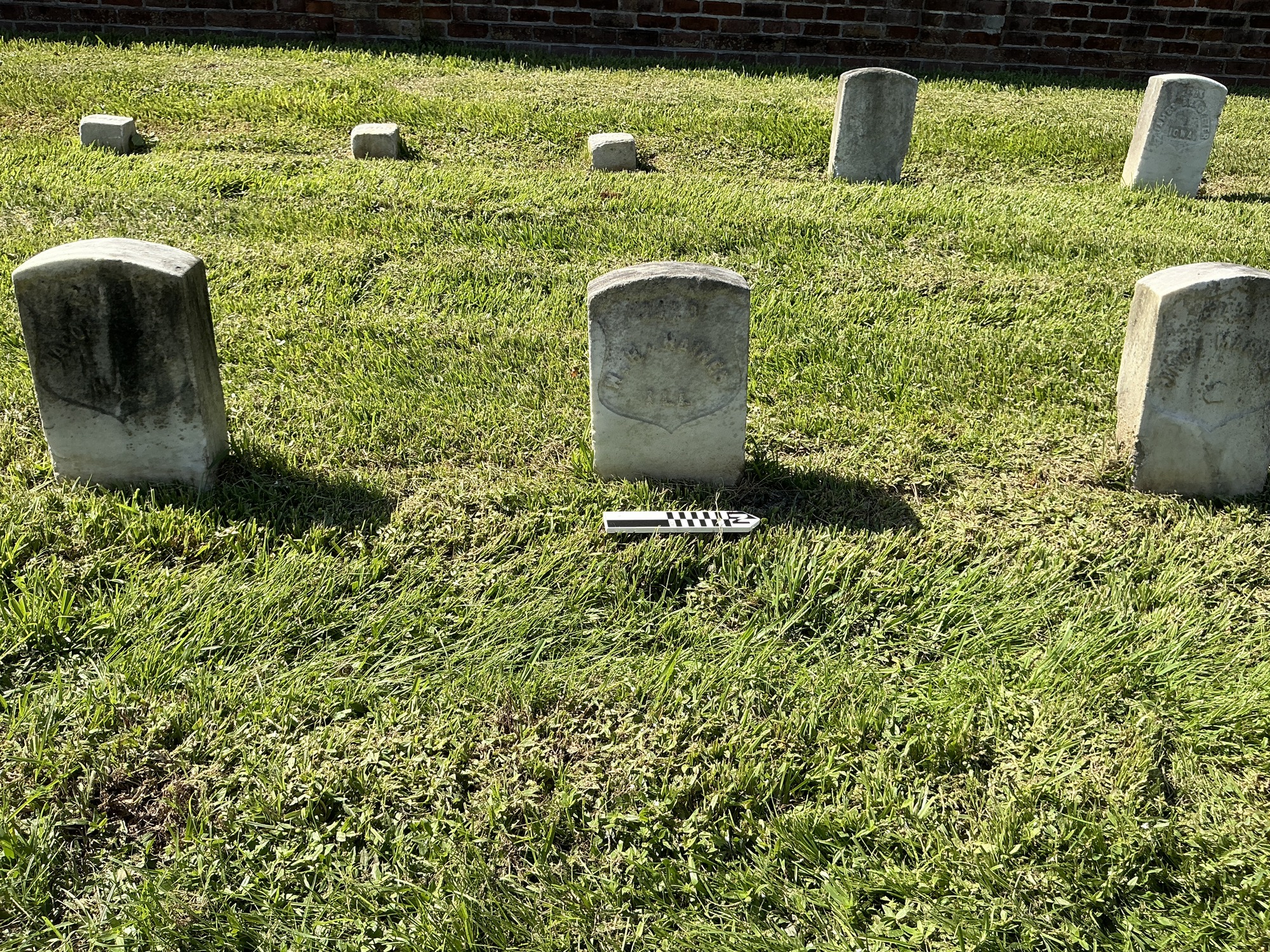 Extra image of historic upright marble headstone with recessed shield face.