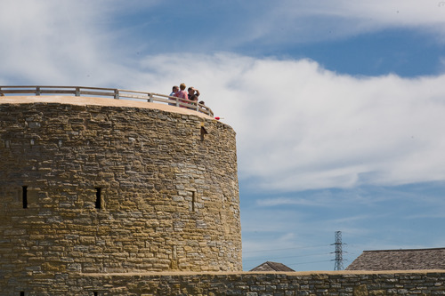 People stand on top of an old fort.