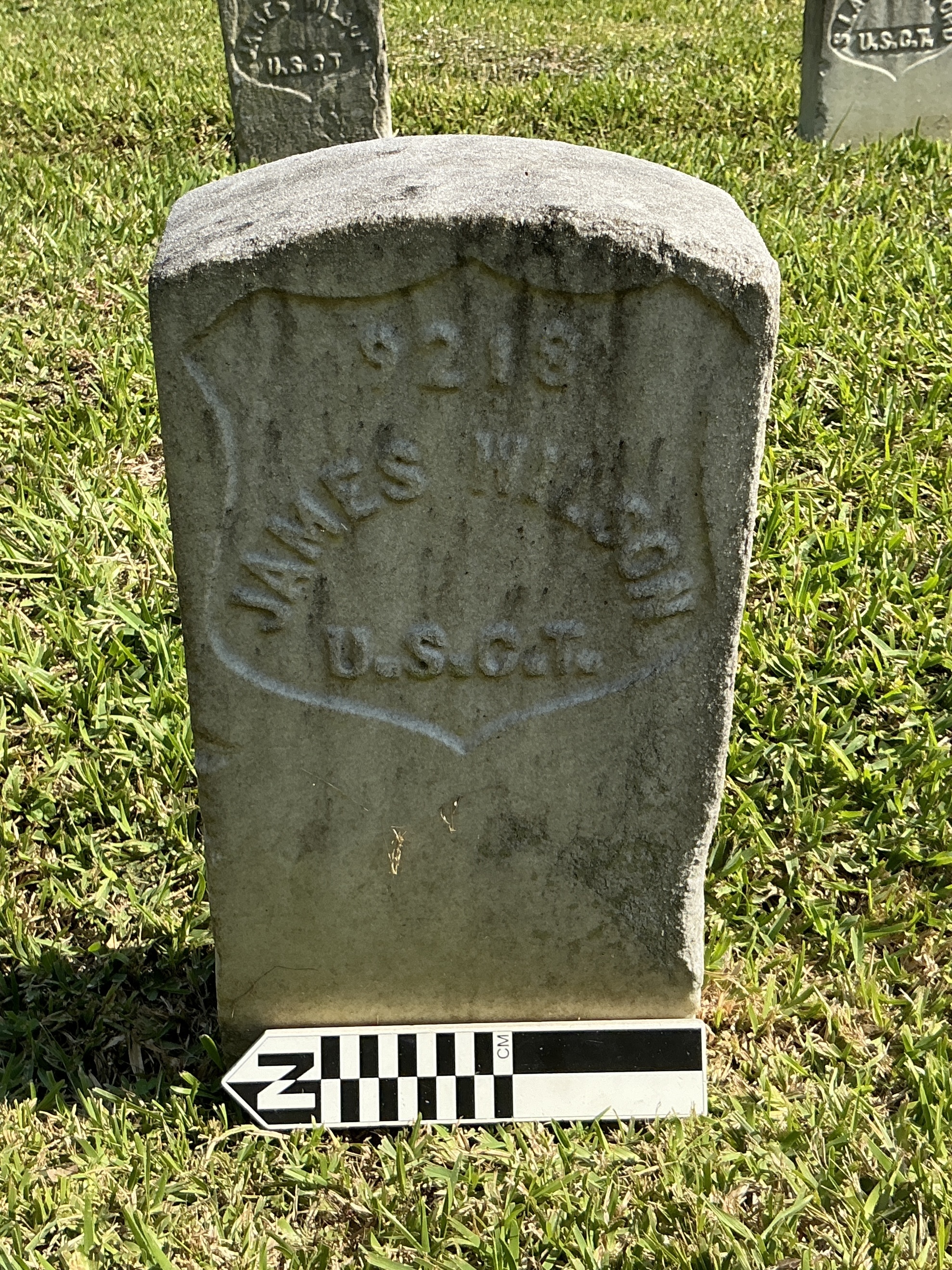 Extra image of historic upright marble headstone with recessed shield face.
