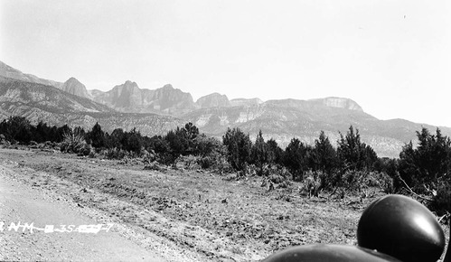 Kolob peaks, view from the New Harmony road which is west of highway 91 (I-15). Headlight and fender in foreground of frame.