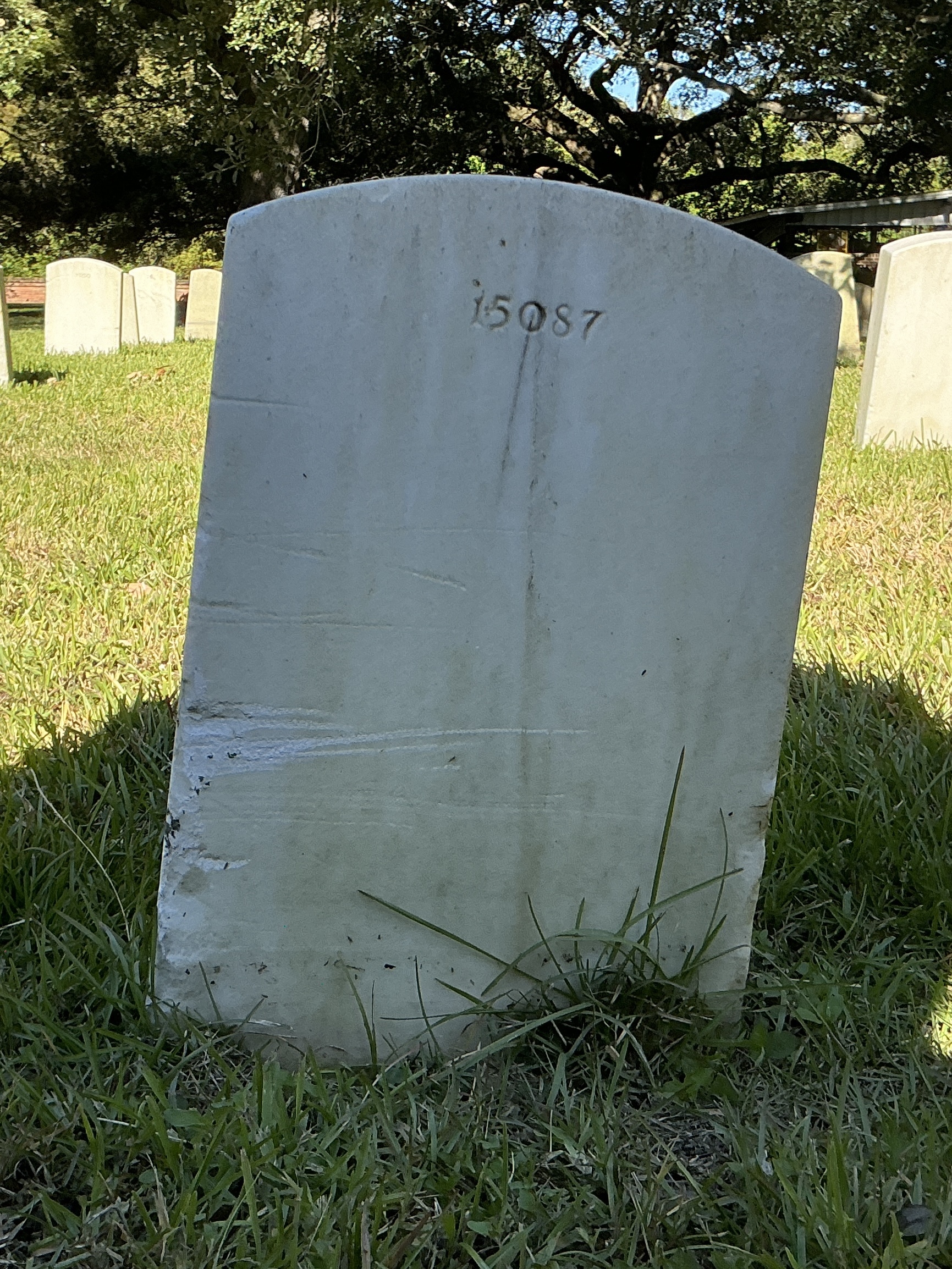 Back of upright marble headstone with flat face.