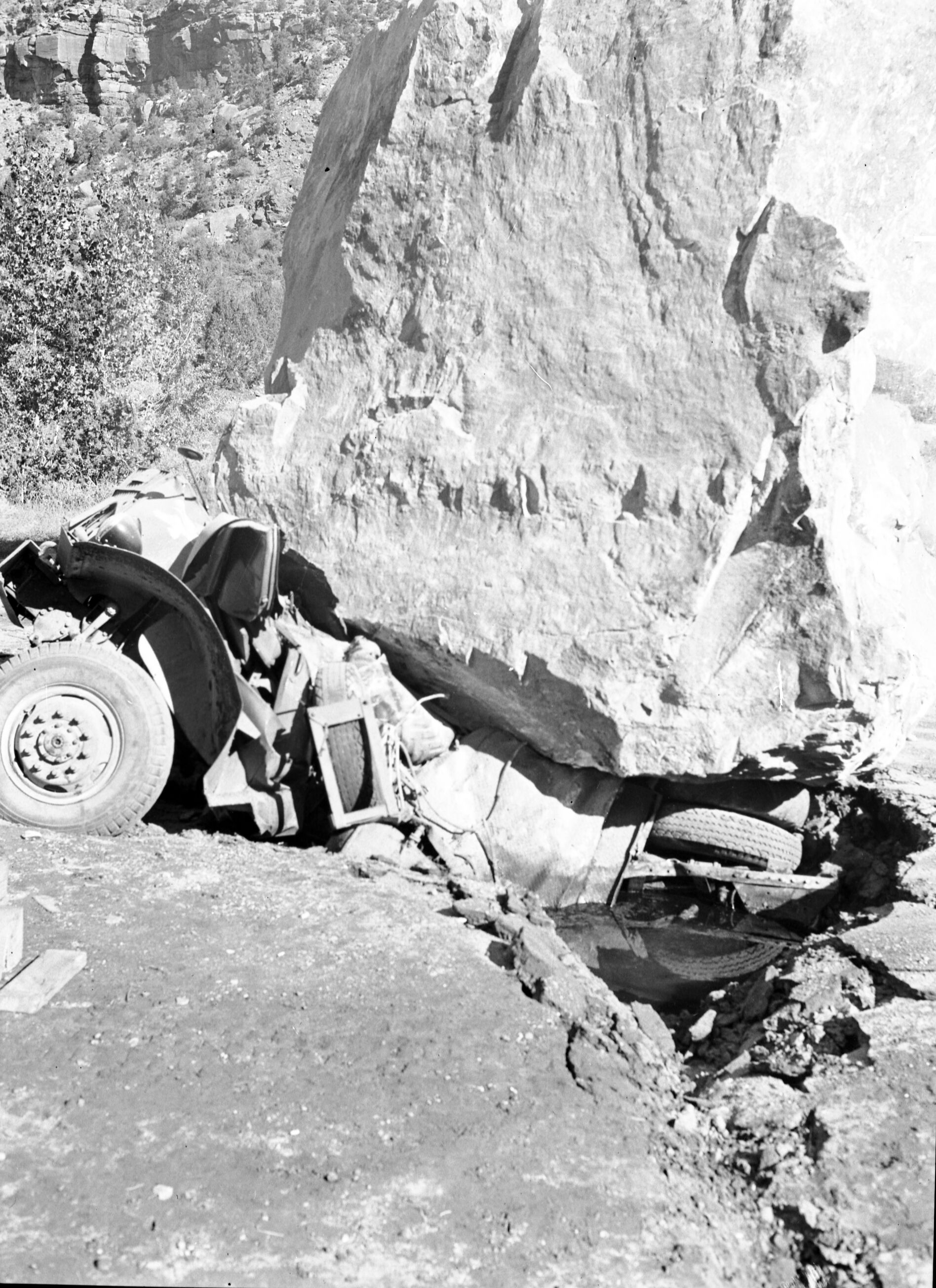 880-ton boulder on empty lowboy trailer behind a truck.