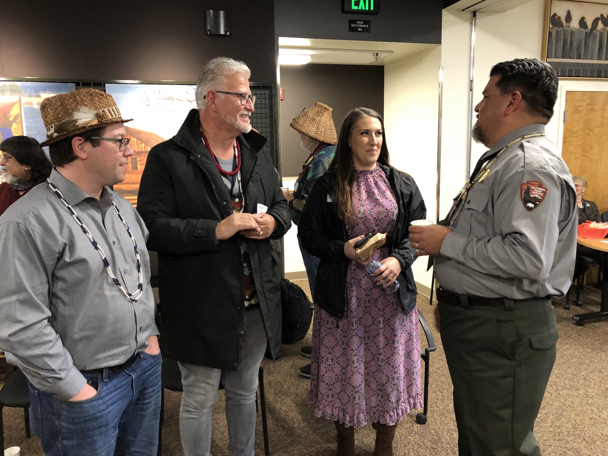 Director Sams in NPS uniform talking with two men and one woman.