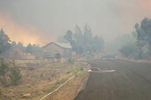 Burning and smoke in and around structures during the Long Mesa Fire, Mesa Verde National Park, July-August 2002
