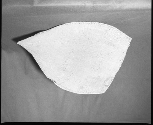 Mrs. Donald Segerstrom Collection. Object: Washoe or Northern Paiute winnower. Dimensions: 29 x 23". Materials: Entirely willow. Technology: Diagonally twined, up to right slant of turns of twining, warp rods twined over one another at finish, bulk of rimstick missing at selvage. Photographed by Michael Dixon. Catalogued by Craig Bates and Barbara Beroza. Yosemite Collections, National Park Service. 1/83.