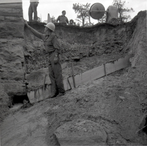 Men working on repairing retaining wall along East Rim road.