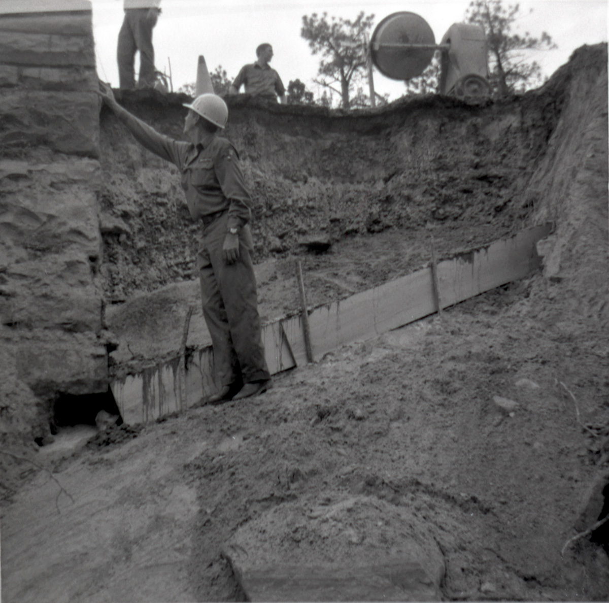 Men working on repairing retaining wall along East Rim road.