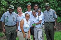 YCC members and staff pose for a group shot outside in the park gardens.