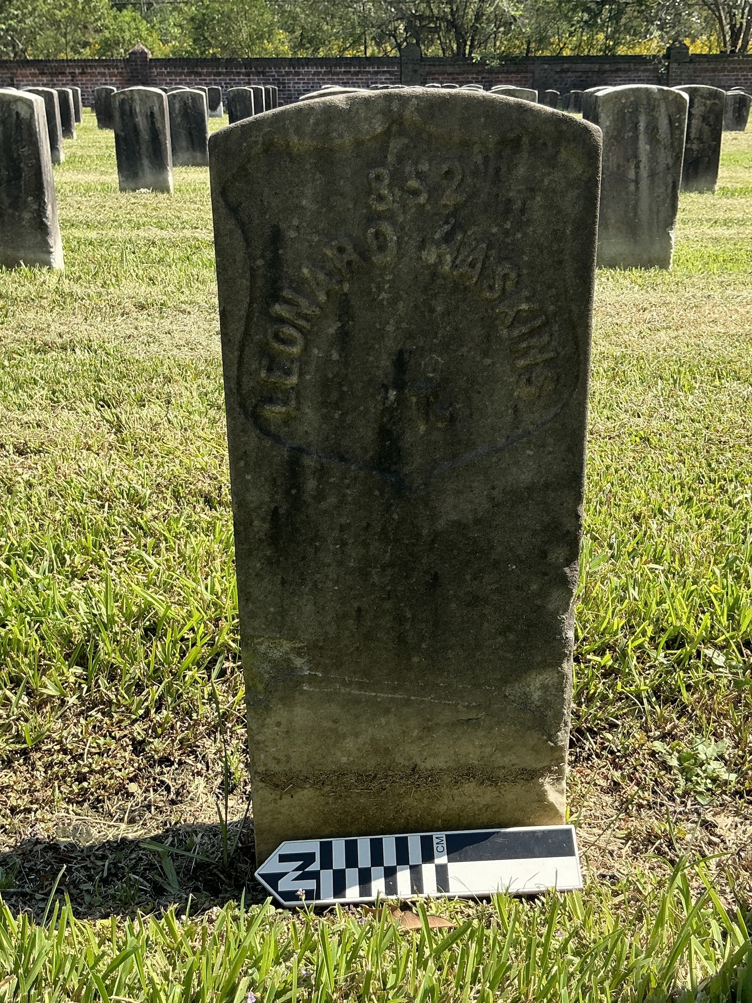 Extra image of historic upright marble headstone with recessed shield face.