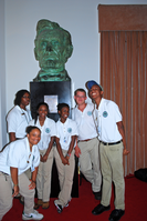 Uniformed YCC members pose around an oversized bust of Abraham Lincoln.