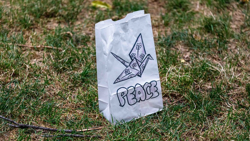 A white back with a drawing of a sandhill crane and puffy letters that spell out "peace."