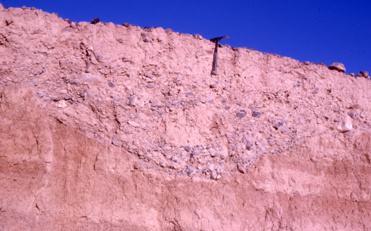 Unidentified photograph of a pickaxe in the side wall of a trench