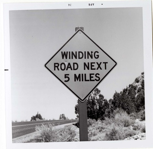 Road sign reading 'Winding Road Next 5 Miles' in Kolob Canyon.