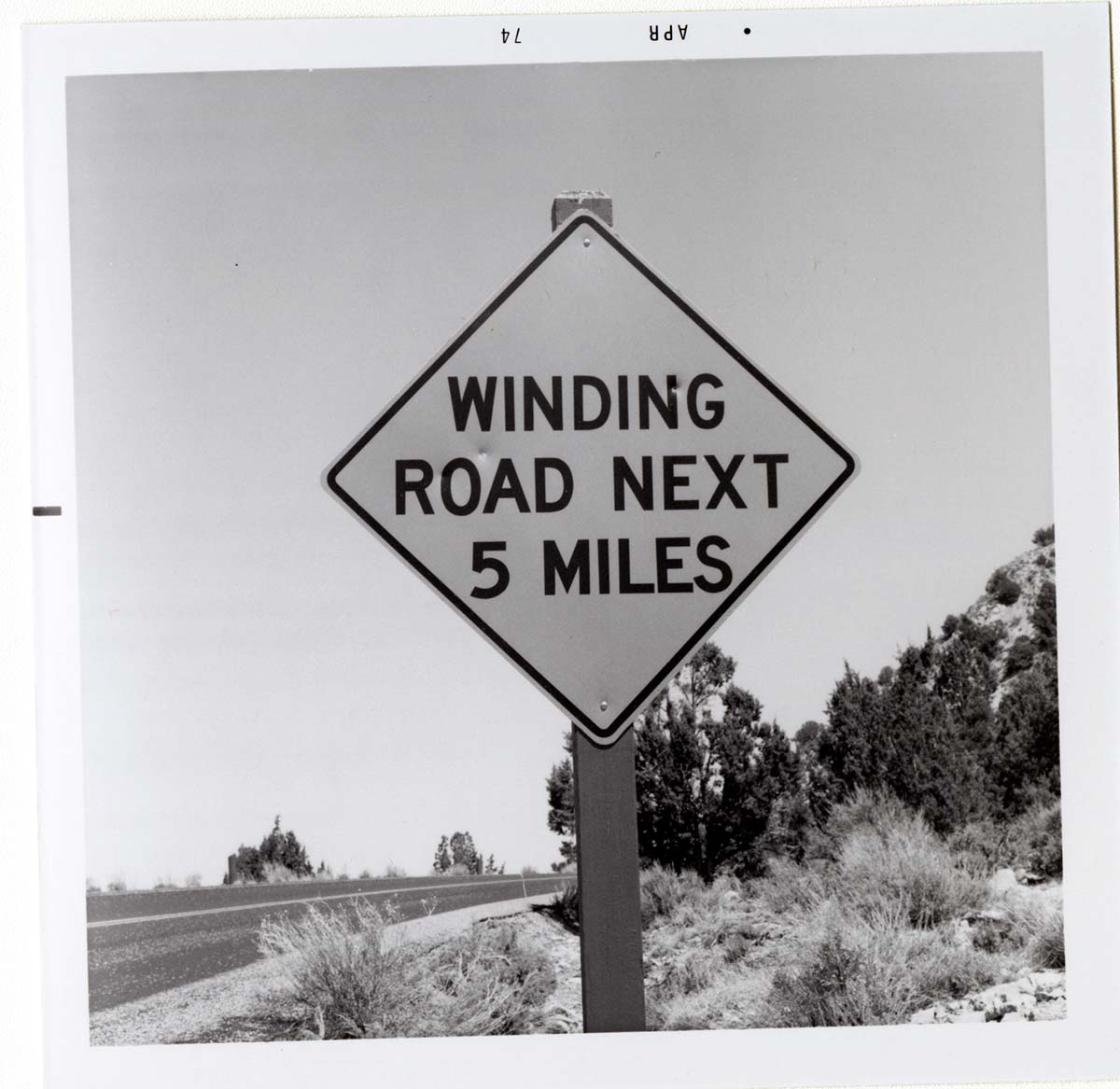 Road sign reading 'Winding Road Next 5 Miles' in Kolob Canyon.