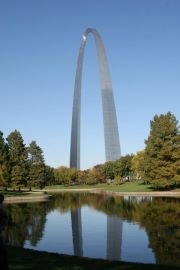 A portion of the Arch is reflected into the south pond on the park grounds.