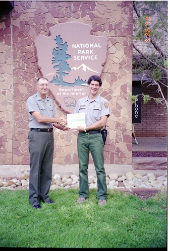 Color Photos of Superintendent Harold Grafe giving out awards to park personnel.
