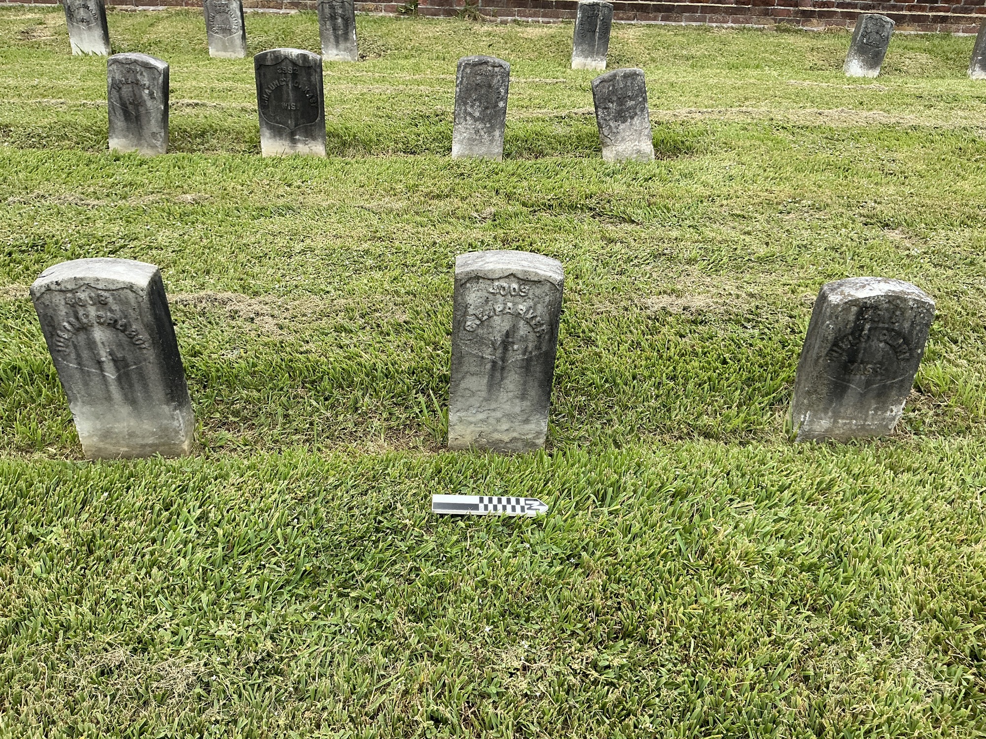 Extra image of historic upright marble headstone with recessed shield face.