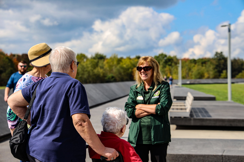 A volunteer talking to visitors.