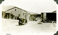 This is an historic black and white photograph from the Scotty's Castle Historic Photograph Collection, Death Valley National Park of Scotty's Castle Stables. Addition for building materials complete. Connecting roof and arched walls of covered Courtyard framed. Circa 1928. Photographed by Mat Roy Thompson.