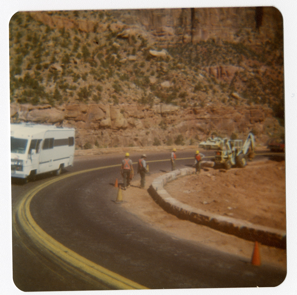 Men positioning traffic cones and preparing roads for chipsealing.