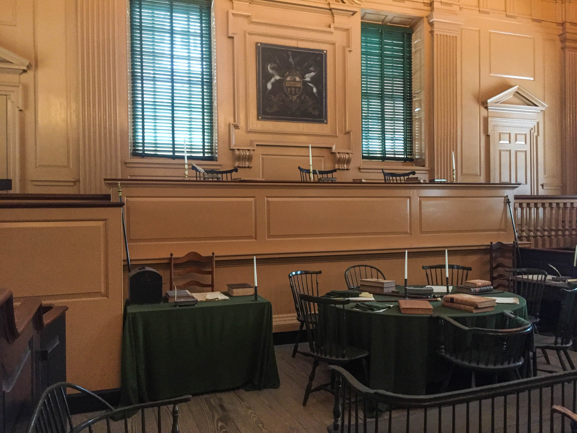 Courtroom with tables, chairs, and paintings