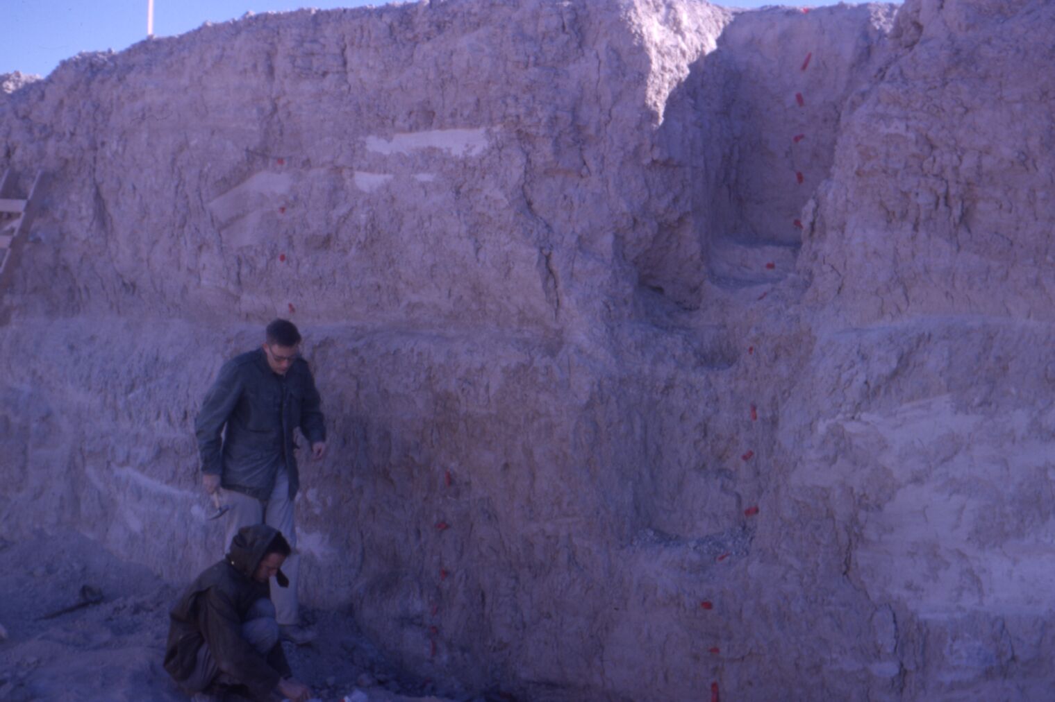Image of two people in trench collecting samples from side walls